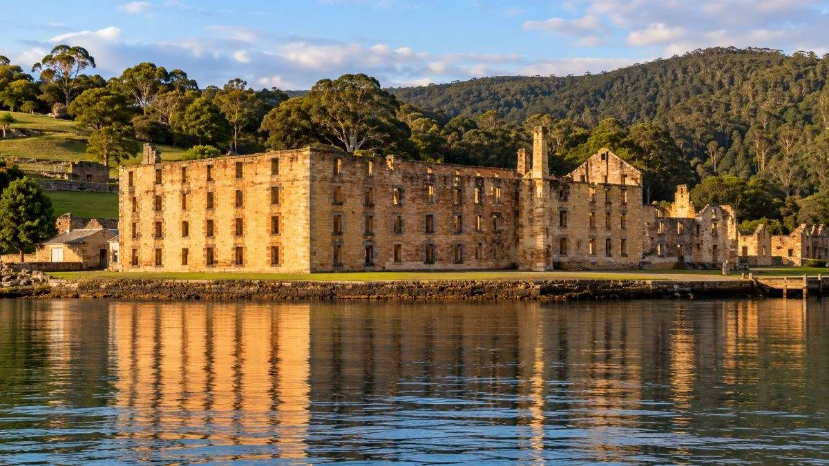 The sandstone Penitentiary at Port Arthur seen across Mason Cove in late afternoon light