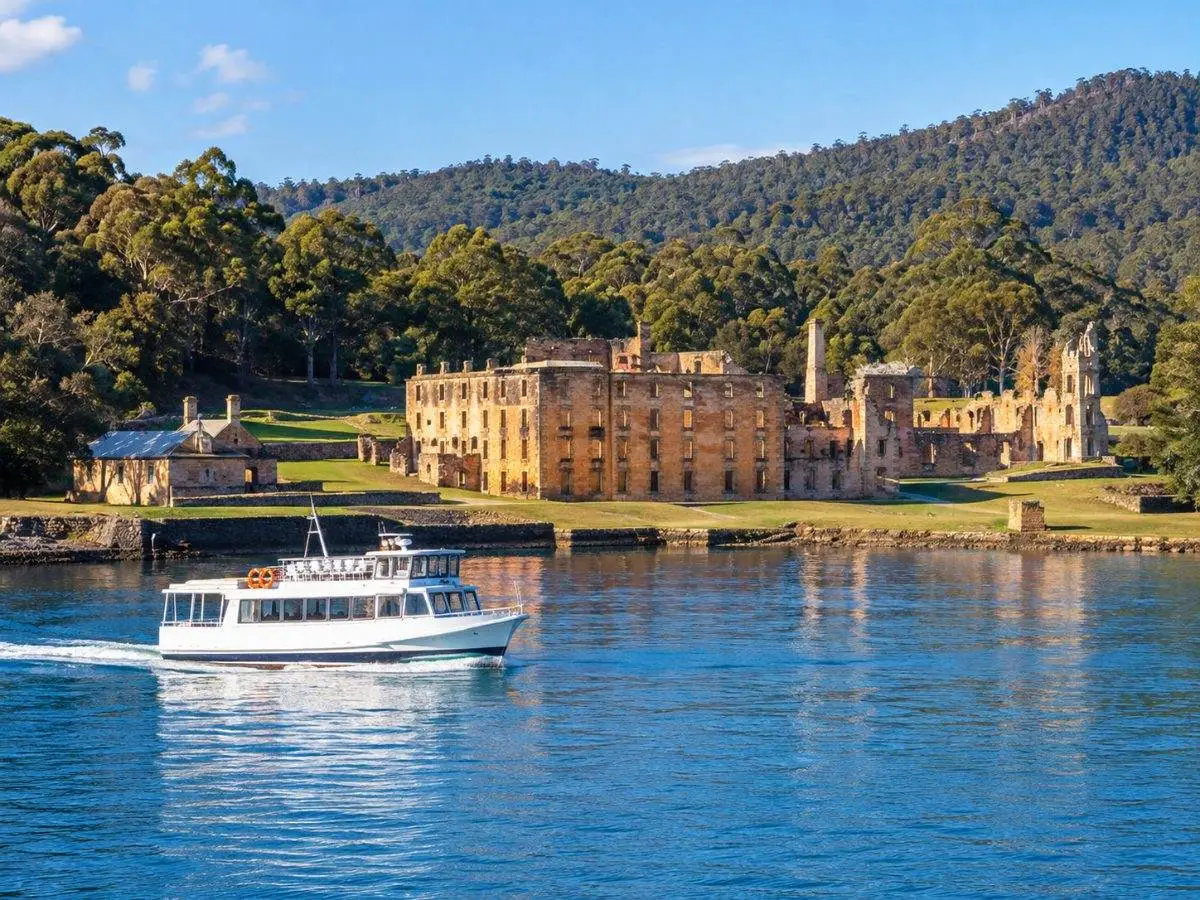 A small harbour ferry on the calm water of Mason Cove below the Port Arthur ruins