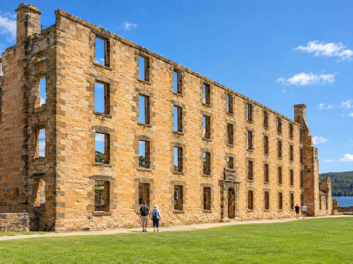 The roofless sandstone Penitentiary at Port Arthur with rows of empty window openings